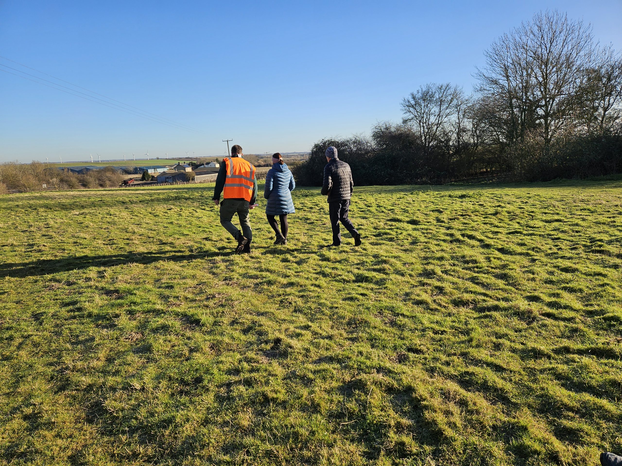 Climate lead, Onyett's Field Lead and HDC Operations Organiser walk across the field to discuss requirements. 